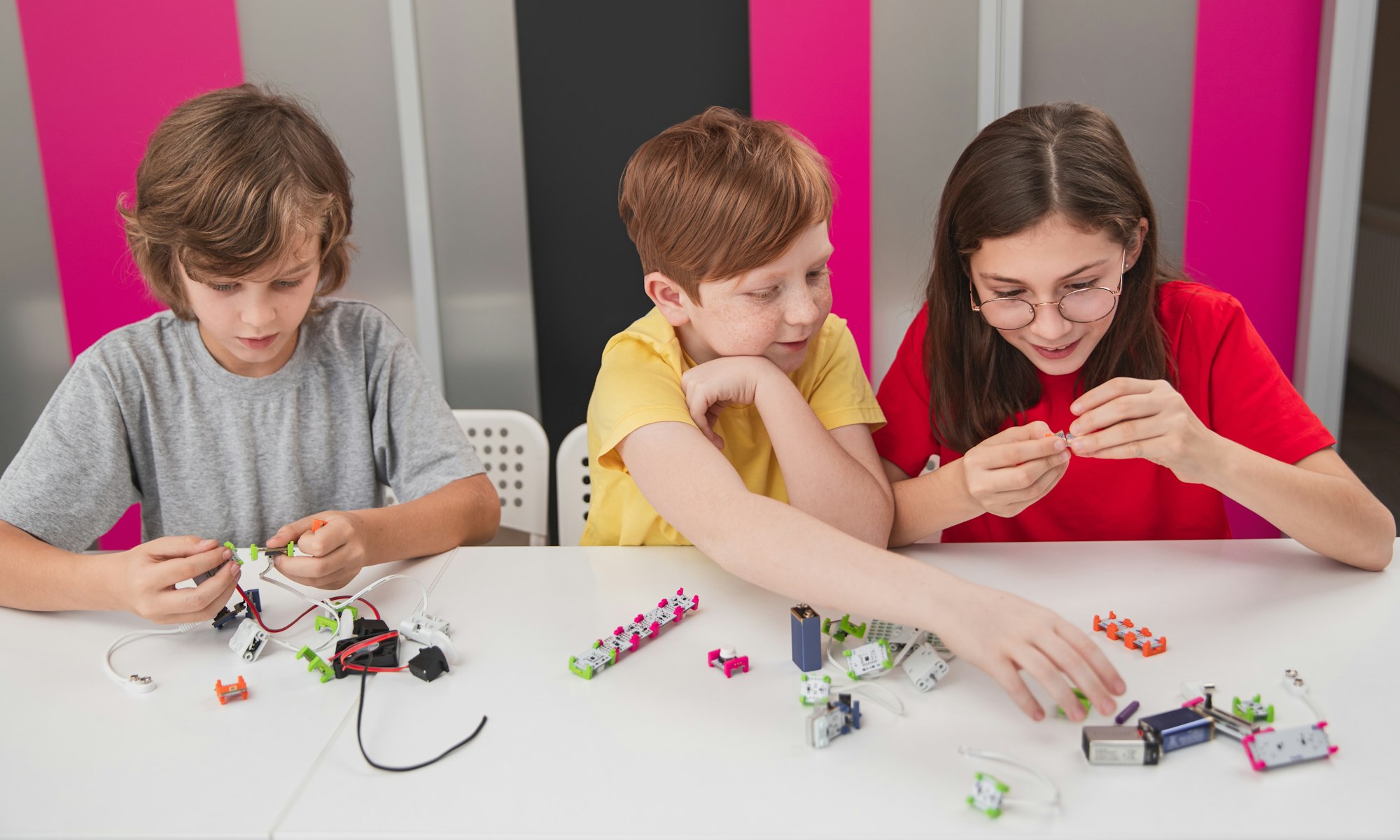 Schoolkids making robots in classroom